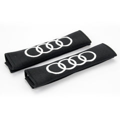 Audi logo in white embroidery on padded seat belt covers.